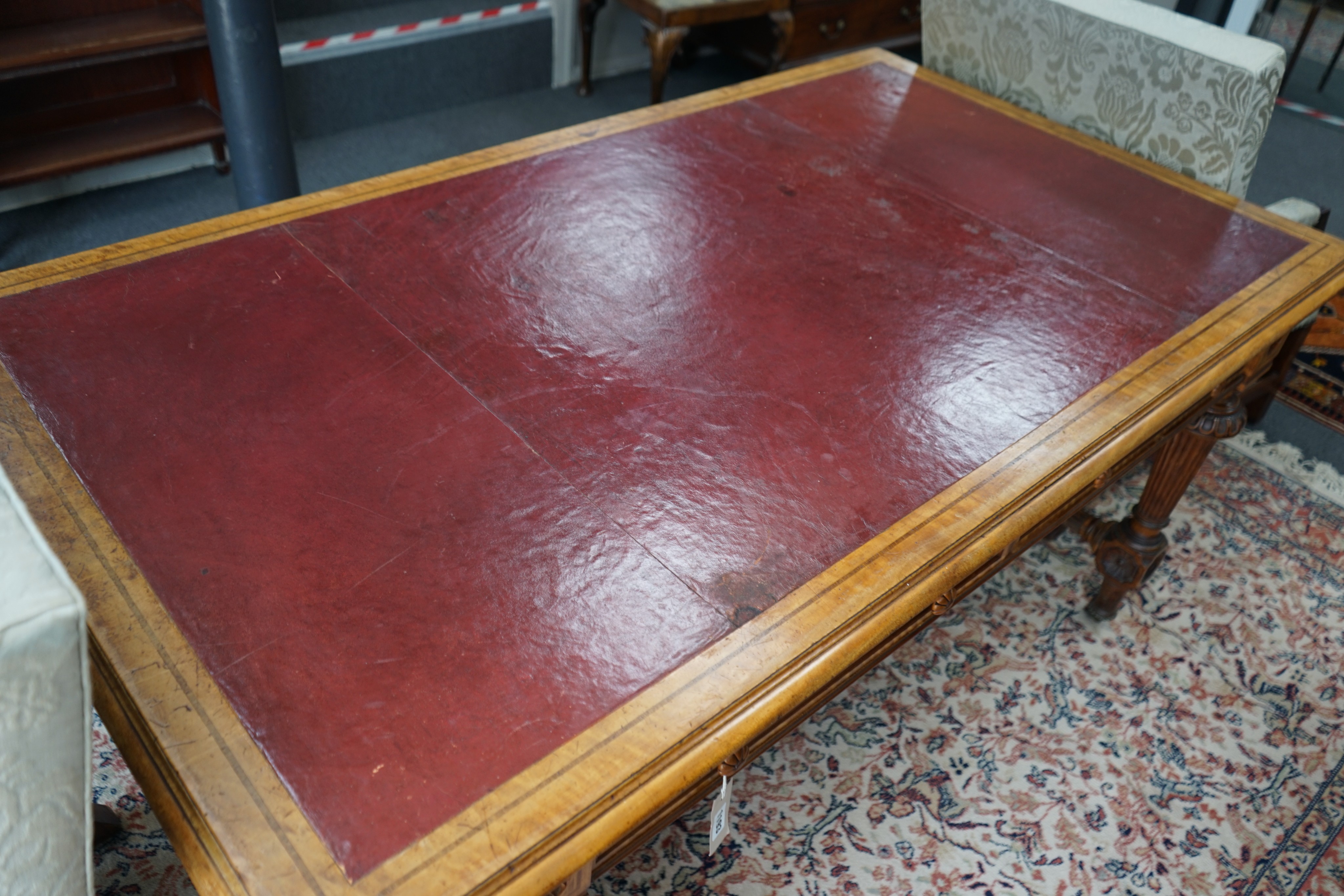 A late Victorian Holland & Sons banded satinwood two drawer library table, retailed by S & H Jewell, width 168cm, depth 96cm, height 76cm